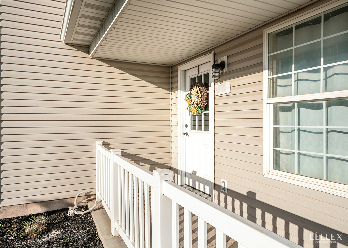 With a house covered with siding