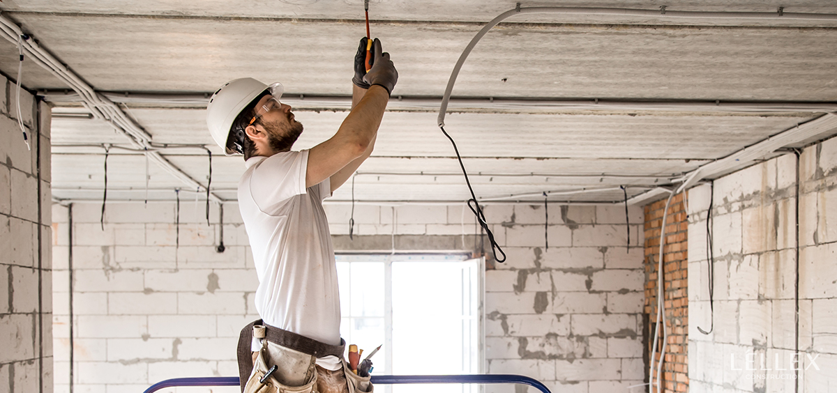 A man installs electricity on the ceiling