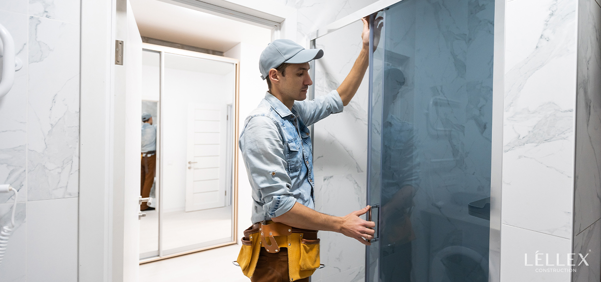 a man installs a shower glass
