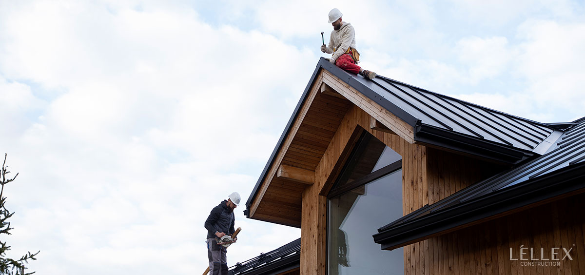 Two men are installing the roof