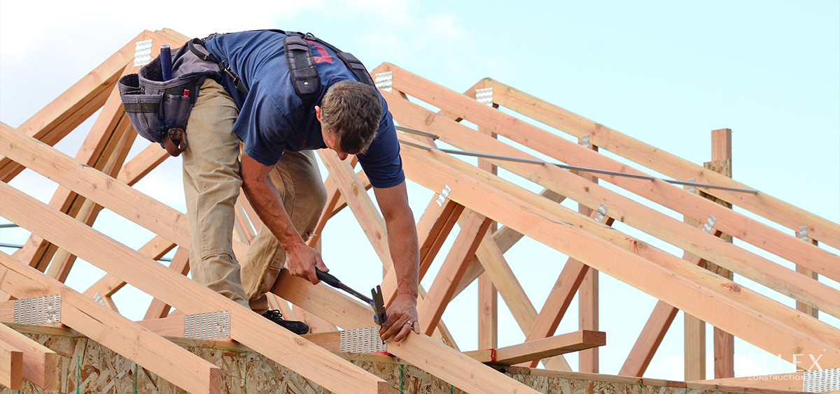a builder builds the roof frame of a house