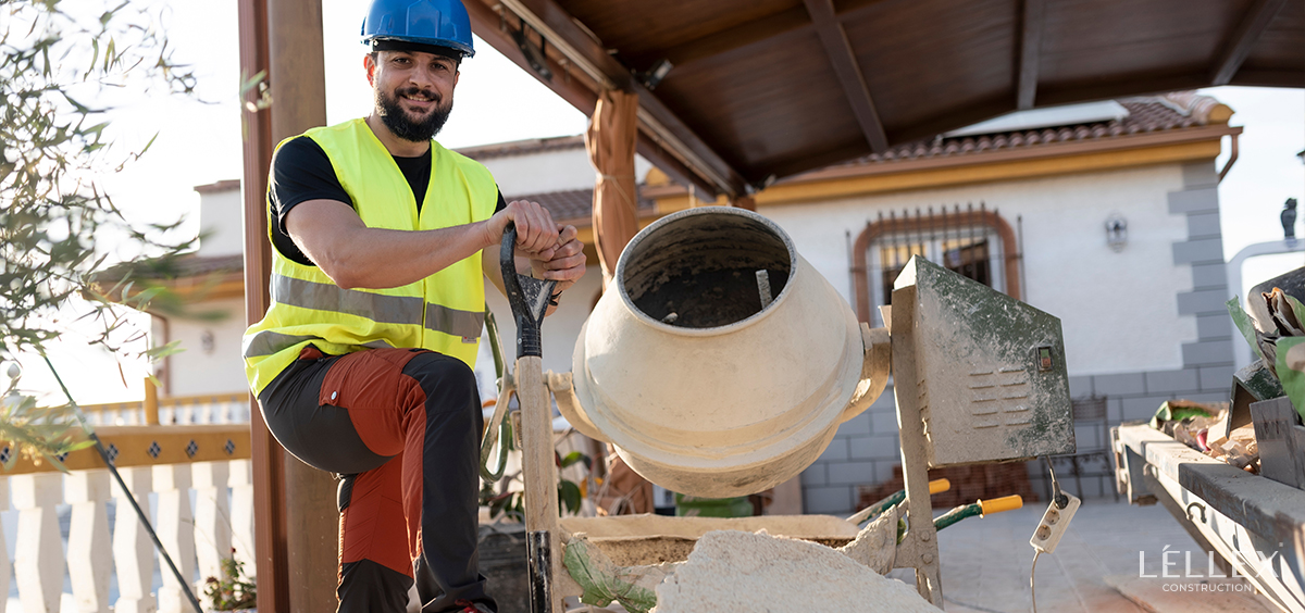 a man mixes concrete for a house in a concrete mixer