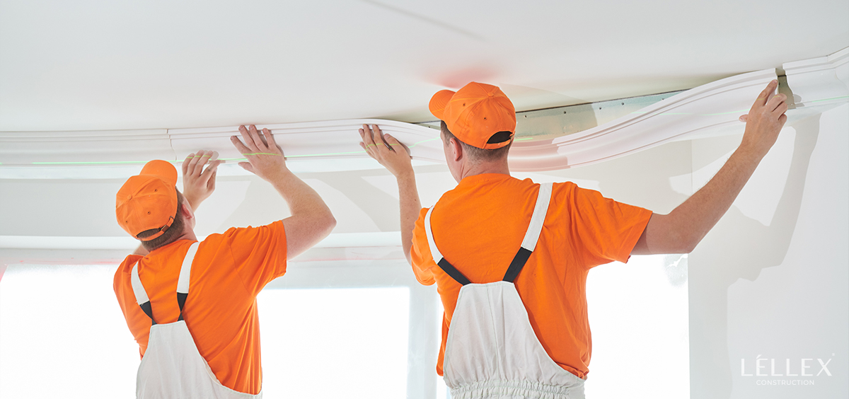 men installing white molding