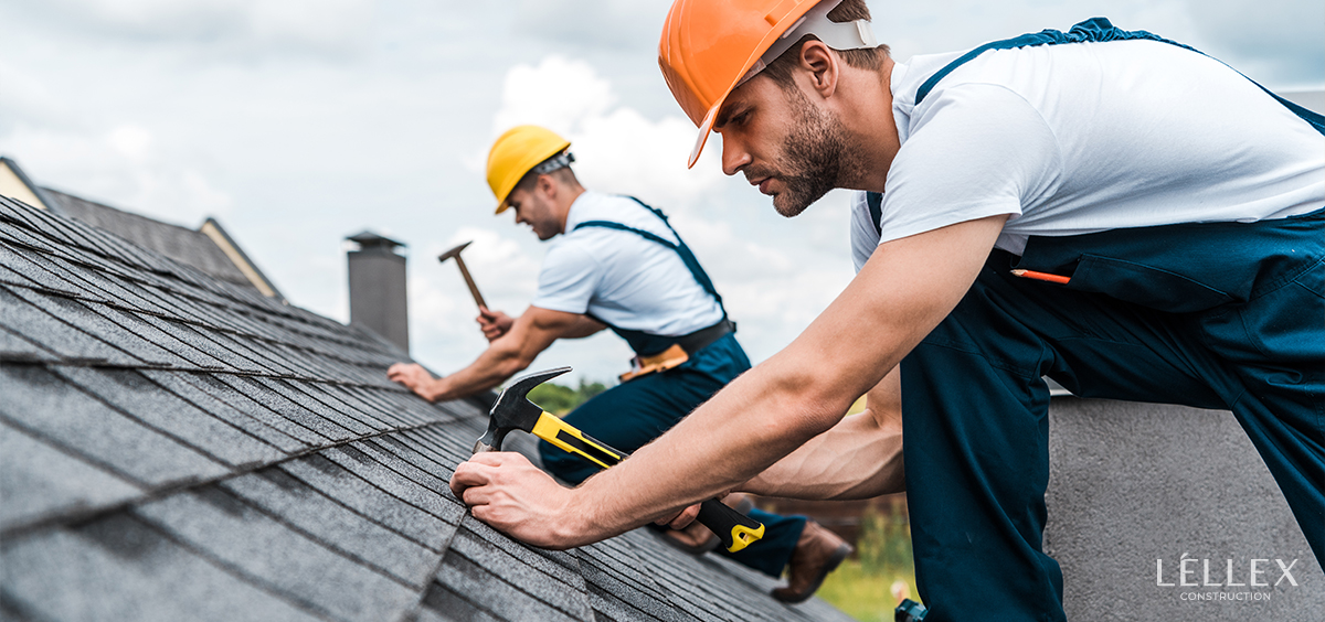 two people install a tile roof