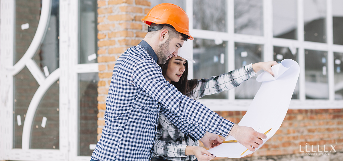 A man and a woman look at a house project