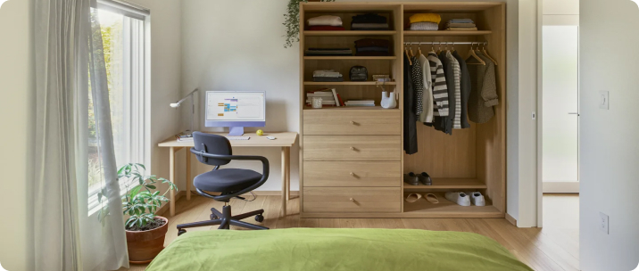a room with a view of the workplace and a closet.