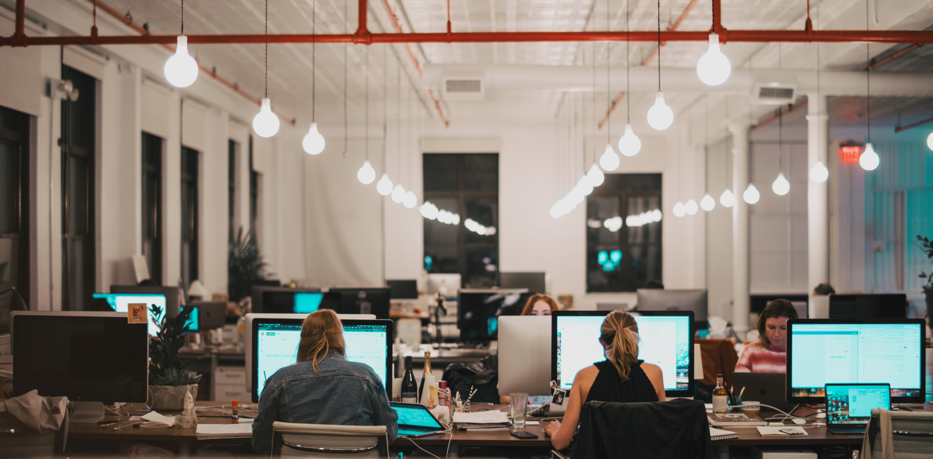 view of the office where employees sit at their computers