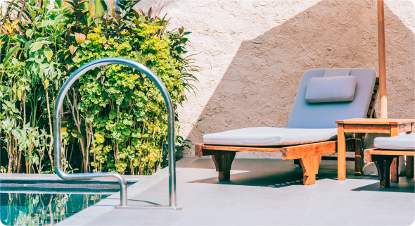 there's a lounge chair by the pool.