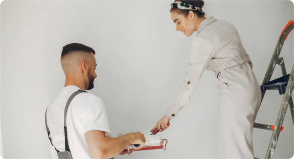 a man and a woman paint a wall with a roller.